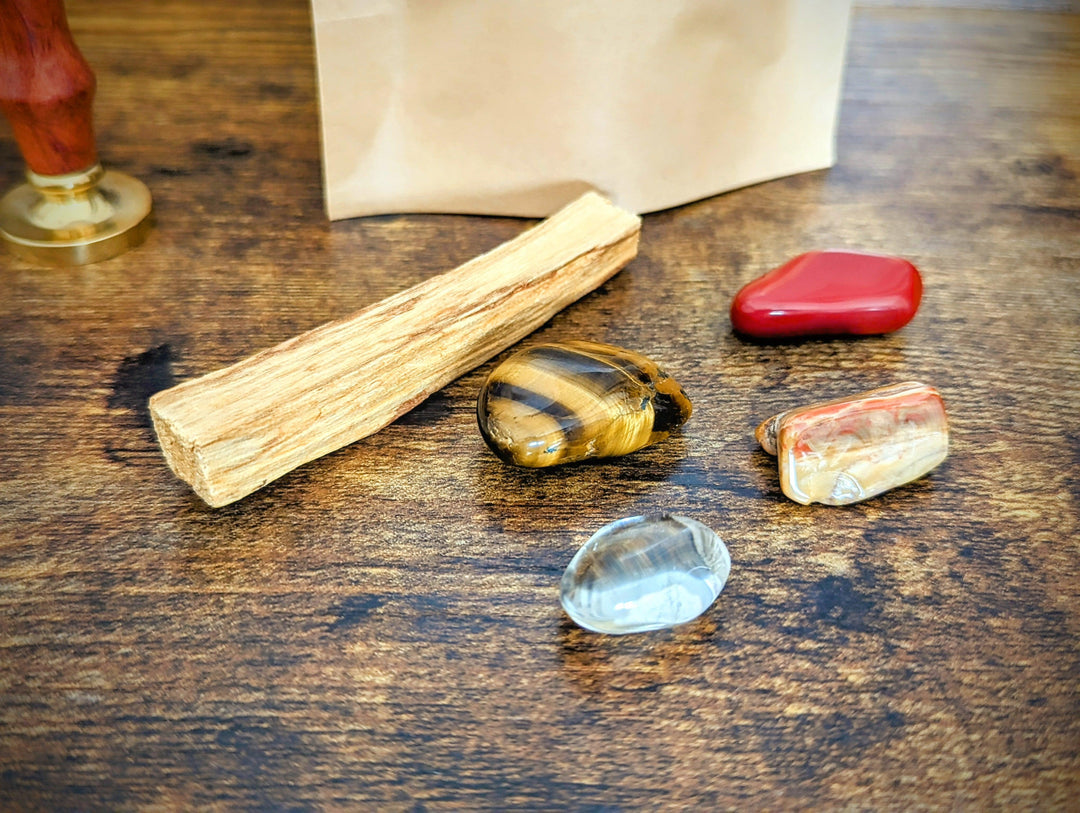 kit nouveau départ avec les pierres d'oeil de tigre de cristal de roche de bois fossile et de jaspe rouge avec un bois de palo santo 